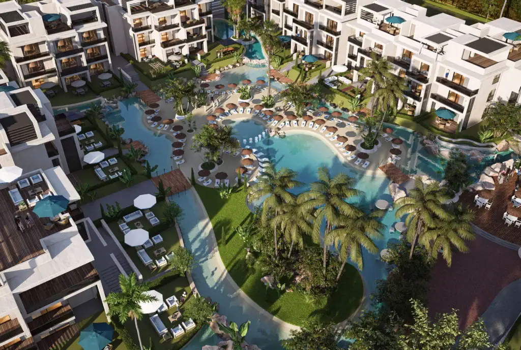 Aerial view of a modern resort with multiple pools and lush landscaping in Hurghada.