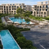 Modern pool with sun loungers and greenery at Trivana, Hurghada.