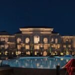 Elegant villa with illuminated pool and palm trees in Hurghada.