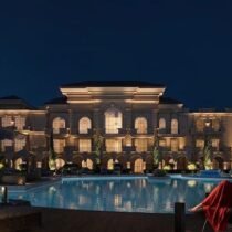 Elegant villa with illuminated pool and palm trees in Hurghada.