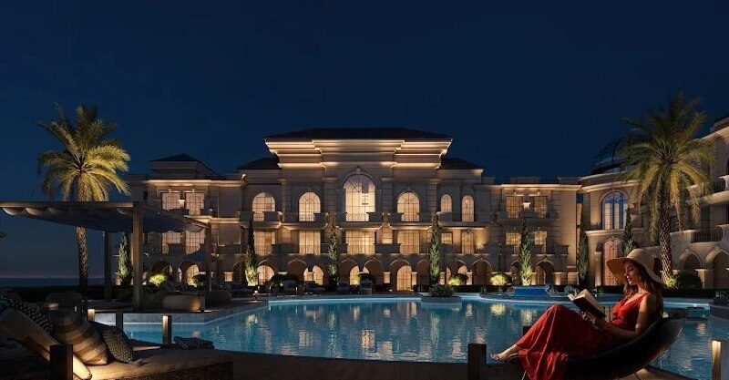 Elegant villa with illuminated pool and palm trees in Hurghada.