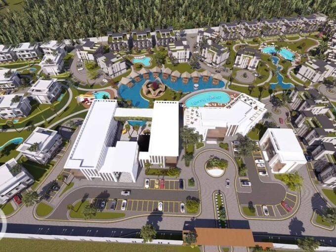Luxurious resort complex with pools, modern buildings, and lush landscaping in Hurghada.