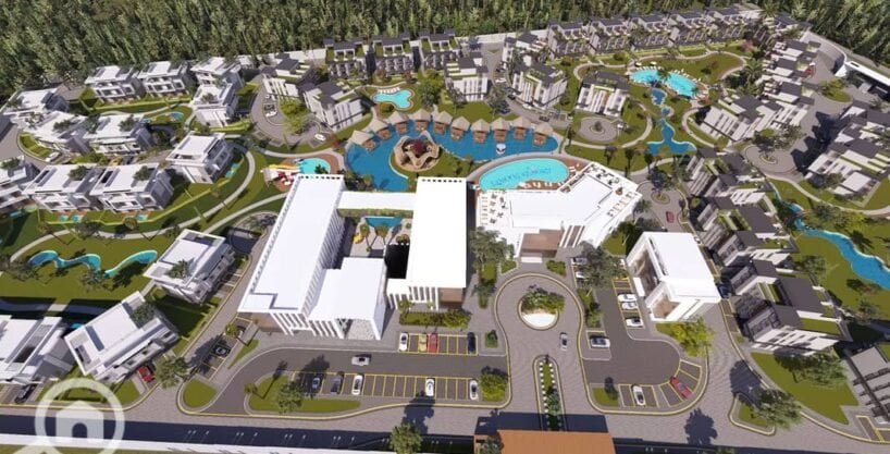 Luxurious resort complex with pools, modern buildings, and lush landscaping in Hurghada.