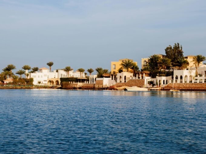 Sea view property facade in Hurghada with resort-style buildings and palm trees.