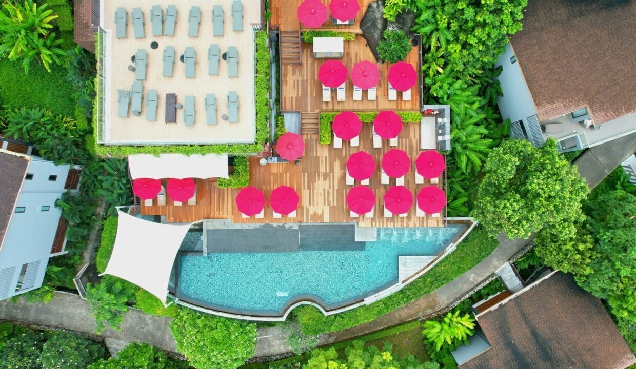 Pool and lounge area with sunbeds and umbrellas in Hurghada property.
